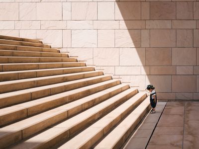 A baby looking at an outdoor stair